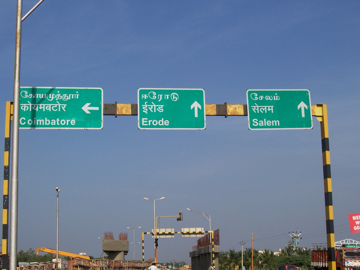 Three green Indian highway signs for Coimbatore, Erode and Salem, each with Tamil above Hindi above English